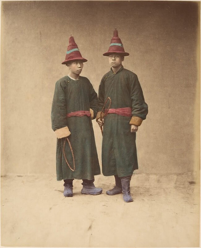 Two chinese men in matching traditional dress and is not AI generated