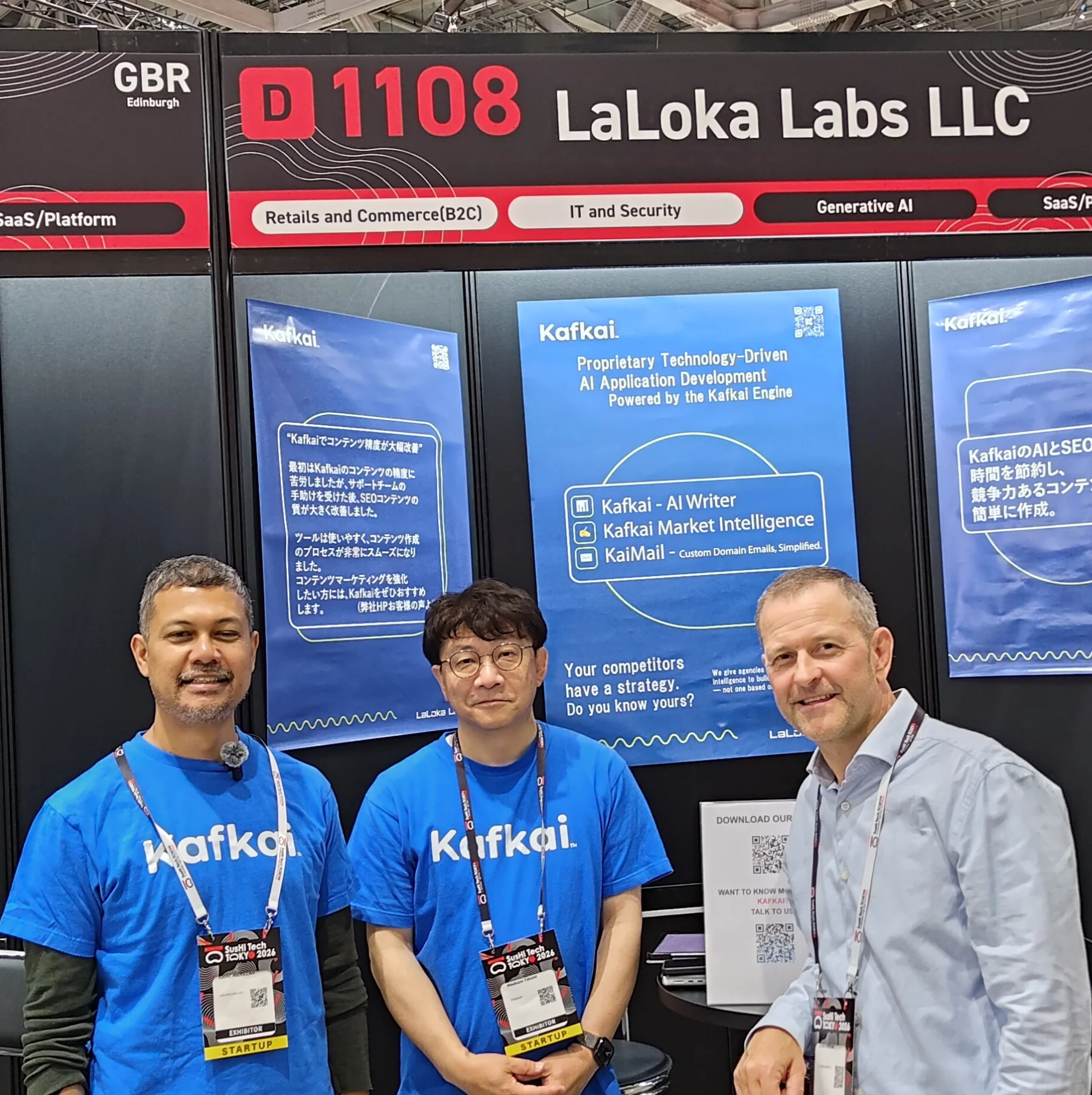Photograph of three men at a trade show booth for LaLoka Labs LLC featuring Kafkai AI writer and SusHI Tech 2026 branding.